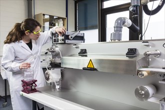 Doctoral student during her research work on a film drawing bench at the Institute for Pharmaceutical Technology and Biopharmacy at Heinrich-Heine-University Duesseldorf