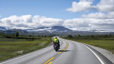 Motorcyclists on road through tundra