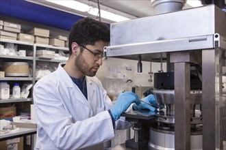 Scientists during their research work on a tablet press at the Institute for Pharmaceutical Technology and Biopharmacy at Heinrich-Heine-University Duesseldorf