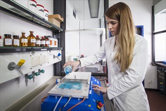 Doctoral student during her research work on a small film drawing bench in the laboratory at the Institute for Pharmaceutical Technology and Biopharmacy at the Heinrich-Heine-University Duesseldorf