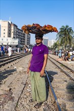 Street vendor on the railway tracks going through Kawran Bazar