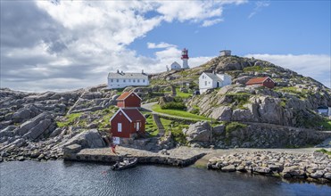 Houses and red and white Lindesnes lighthouse