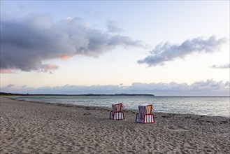 Lonely beach chairs in the morning light at the big beach of Thiessow