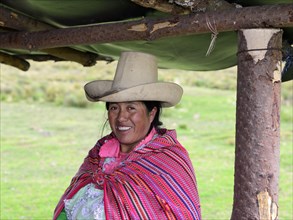 Indigenous woman with typical hat smiling at the camera