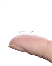 Contact lens on a finger against a white background