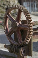 Rusty gear wheel of a weir