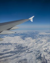 View of mountains and snowy landscape from the airplane