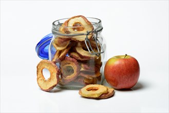 Dried apple rings in glass and apple