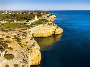 Cliffy coast of Algarve with Alfazinha Lighthouse in Carvoeiro
