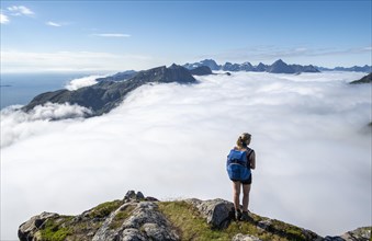 Hiker looking over mountain landscape in fog