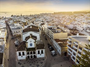 Aerial view of Olhao with a church in the foreground by sunset