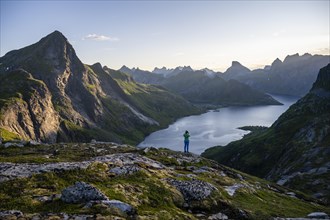 Hiker looking at mountain landscape with fjord Forsfjorden