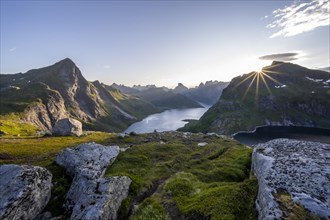 Sun shines over mountain landscape with fjord Forsfjorden and lake Krokvatnet