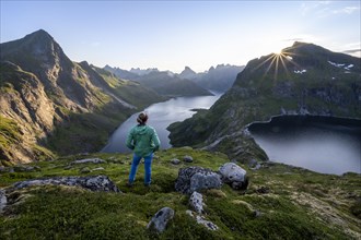 Young woman looking over fjord landscape