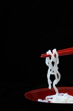 Shirataki noodles made from konjac flour on chopsticks