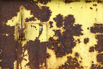 Yellow painted rusty metal plate