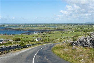 Lonely country road through the karst landscape of The Burren