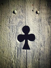 Clover shape cut out of wooden door
