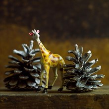 Giraffe figurine and christmas pine cones