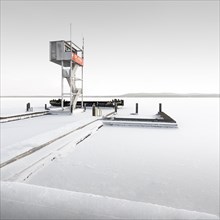 Snowed-in rescue tower in frozen Mueggelsee