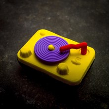 Eraser representing a record player on a textured background