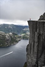 Person standing on steep cliff