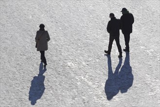 People walking on the snowy Rhine promenade