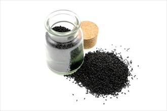 Nigella seeds beside and in a 150ml glass spice jar against a white background