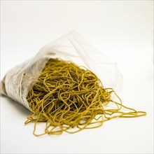 Heap of elastic bands on white background