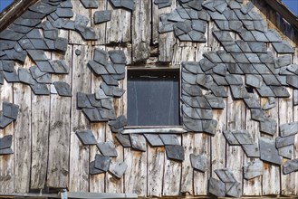 Broken slate facade of an old farmhouse