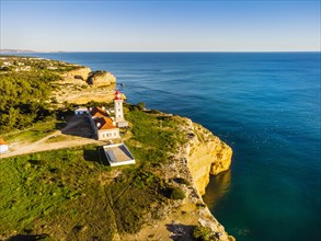 Cliffy coast of Algarve with Alfazinha Lighthouse in Carvoeiro