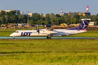 A Bombardier DHC-8-400 of LOT Polskie Linie Lotnicze with registration OY-YBZ at Warsaw Airport