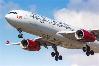 A Virgin Atlantic Airbus A330-300 with the registration G-VGEM lands at London Heathrow Airport