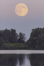 Full moon over the Dammer mountain lake