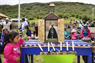Little indigenous girl looking at a shrine during a folk festival