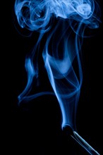 Extinguished match with blue smoke