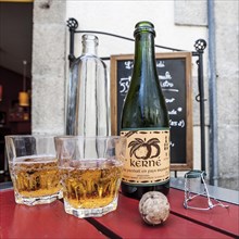 Cider bottle with glasses and a cork