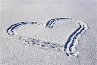 Heart in the snow on frozen lake