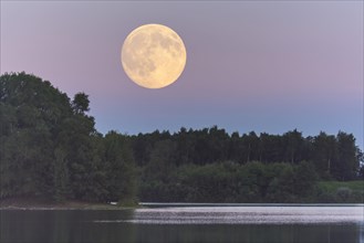 Full moon over the Dammer mountain lake