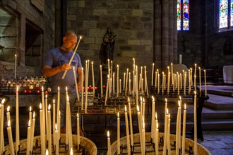 Man lighting a votive candle