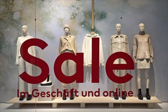 Shop window of a clothing store with the inscription Sale