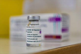 Ampoule and packaging of AstraZeneca's COVID-19 vaccine stand at a vaccination center in Erding
