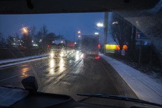 Driving a truck at dawn in winter with poor visibility and road conditions