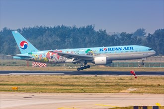 A Korean Air Boeing 777-200ER aircraft with registration number HL7766 in a special livery at Beijing Airport