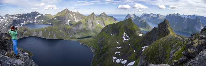 Young woman looking over mountain landscape with lake Tennesvatnet