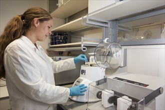 Scientist of biology at the homogenizer for RNA and DNA in the genetic engineering section of the laboratories of the University of Duisburg-Essen