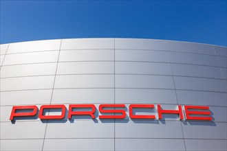 Porsche logo on a car dealership in Stuttgart Zuffenhausen