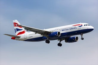 A British Airways Airbus A320 with registration G-EUYM lands at London Heathrow Airport