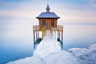 Iced bathhouse at dusk