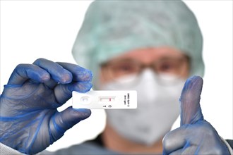 Medical staff shows negative antigen rapid test